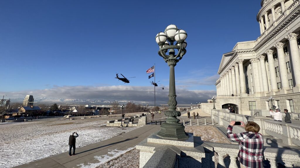 Utah National Guard blackhawk helicopters taking off from the  front lawn of the Utah State Capitol building.