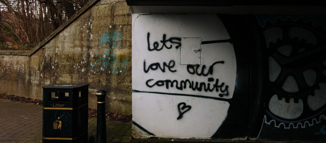 underpass sign that says "Let's Love Our Community"